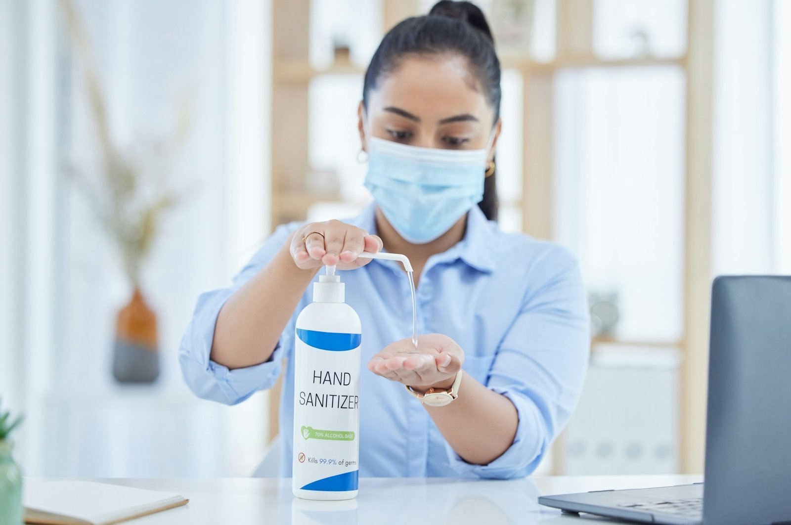 Sanitizer, covid and employee cleaning hands in the office for dusty germs, health and safety in wo